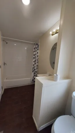 a bathroom with a sink mirror vanity and toilet