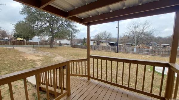 a view of a balcony with wooden floor