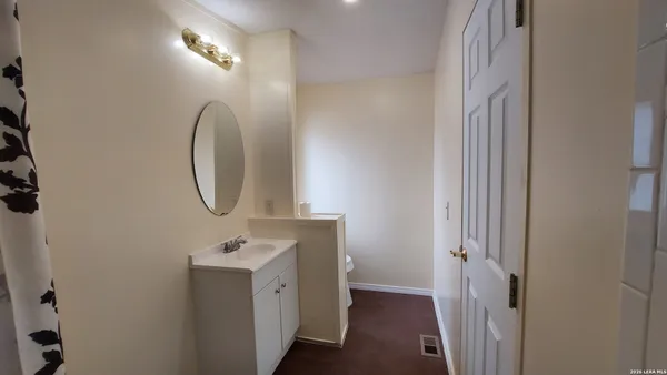 a bathroom with a sink a mirror and a shower