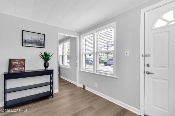 a view of a room with wooden floor and window