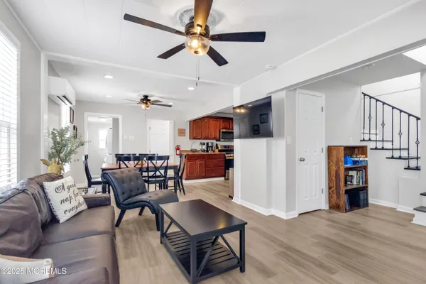 a living room with furniture and a wooden floor