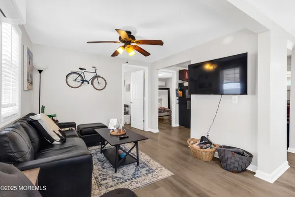 a view of a white house with table and chairs