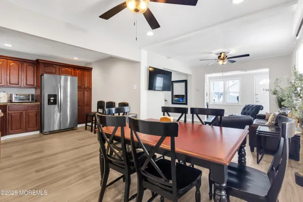 a view of a dining room with furniture and a chandelier