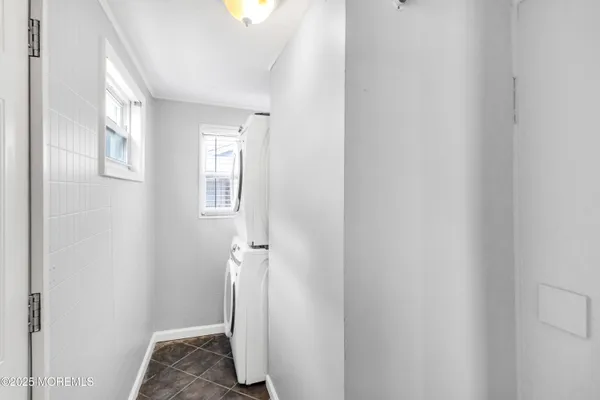 a view of a room with wooden floor and a window