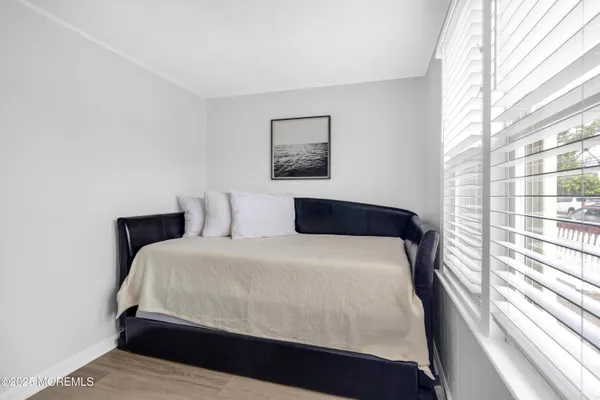 a bedroom with a large bed and a window