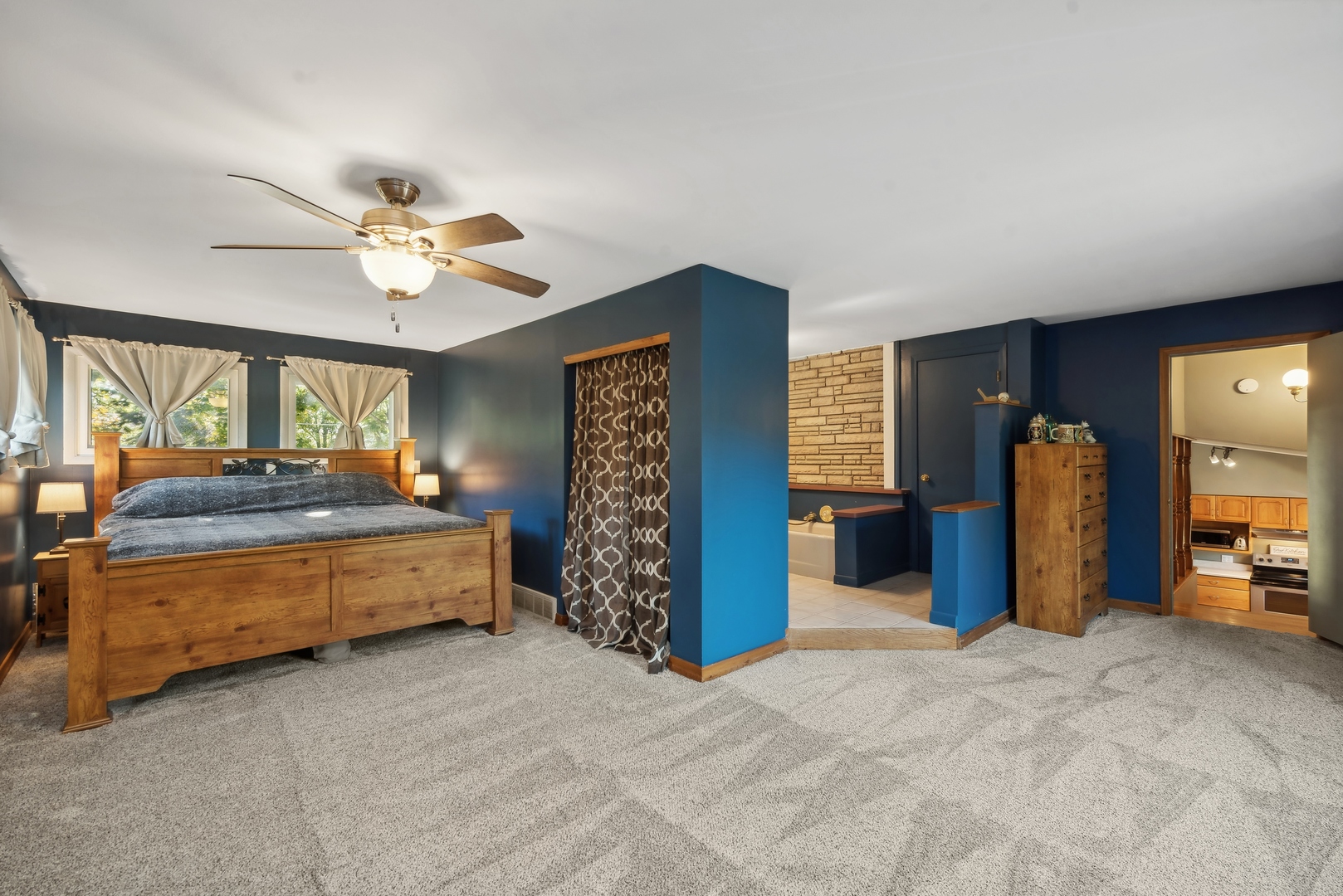 4612 Blue Jay Road Harvard, IL 60033 - Photo 10 of 14 a spacious bedroom with a bed and a chandelier