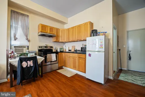 a kitchen with refrigerator and cabinets