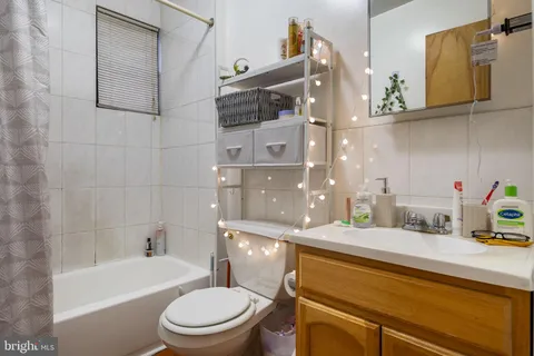 a kitchen with a stove top oven cabinets and a refrigerator