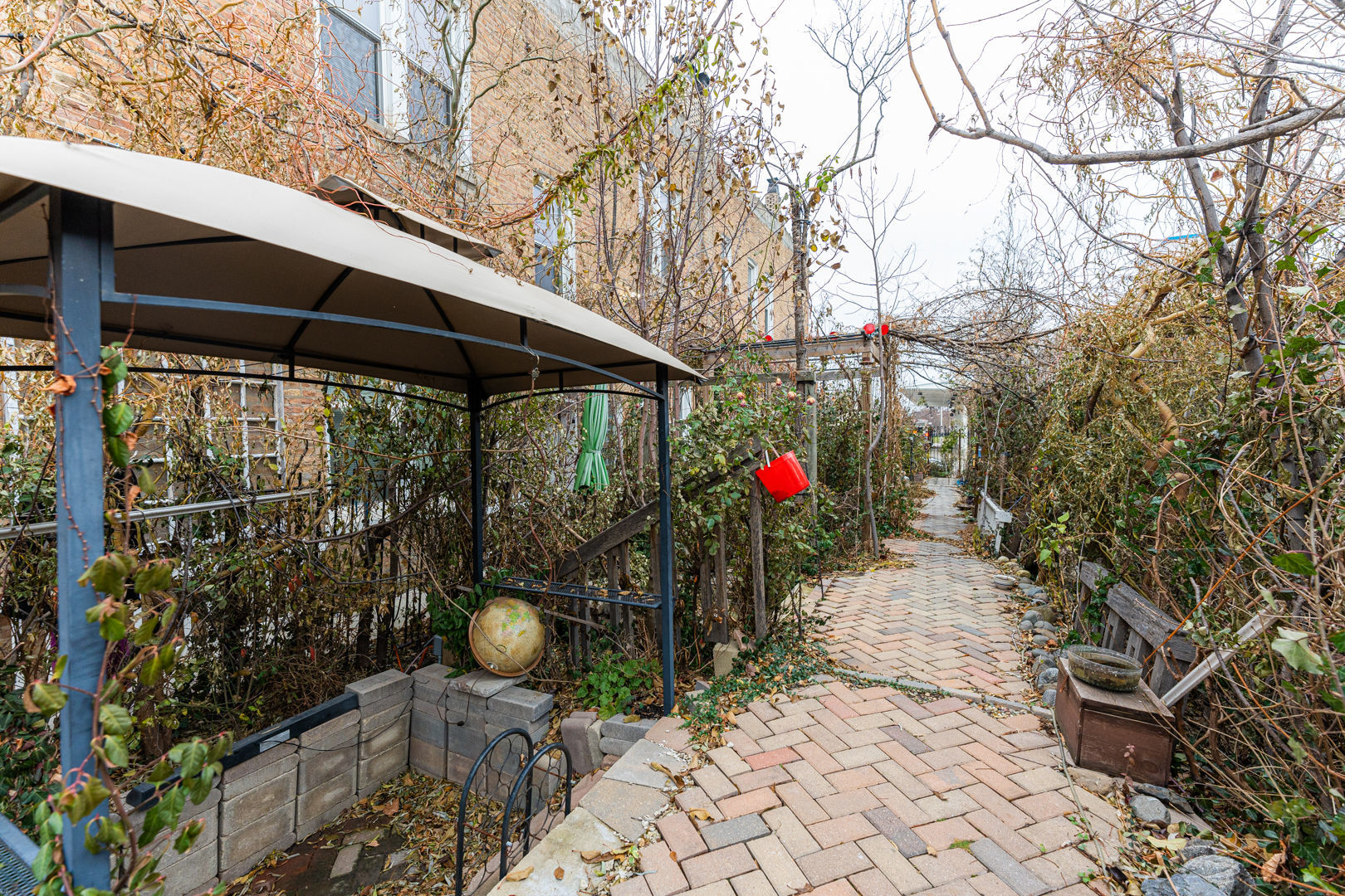 2008 South Pulaski Road Chicago, IL 60623 - Photo 11 of 16 a backyard of a house with table and chairs under an umbrella