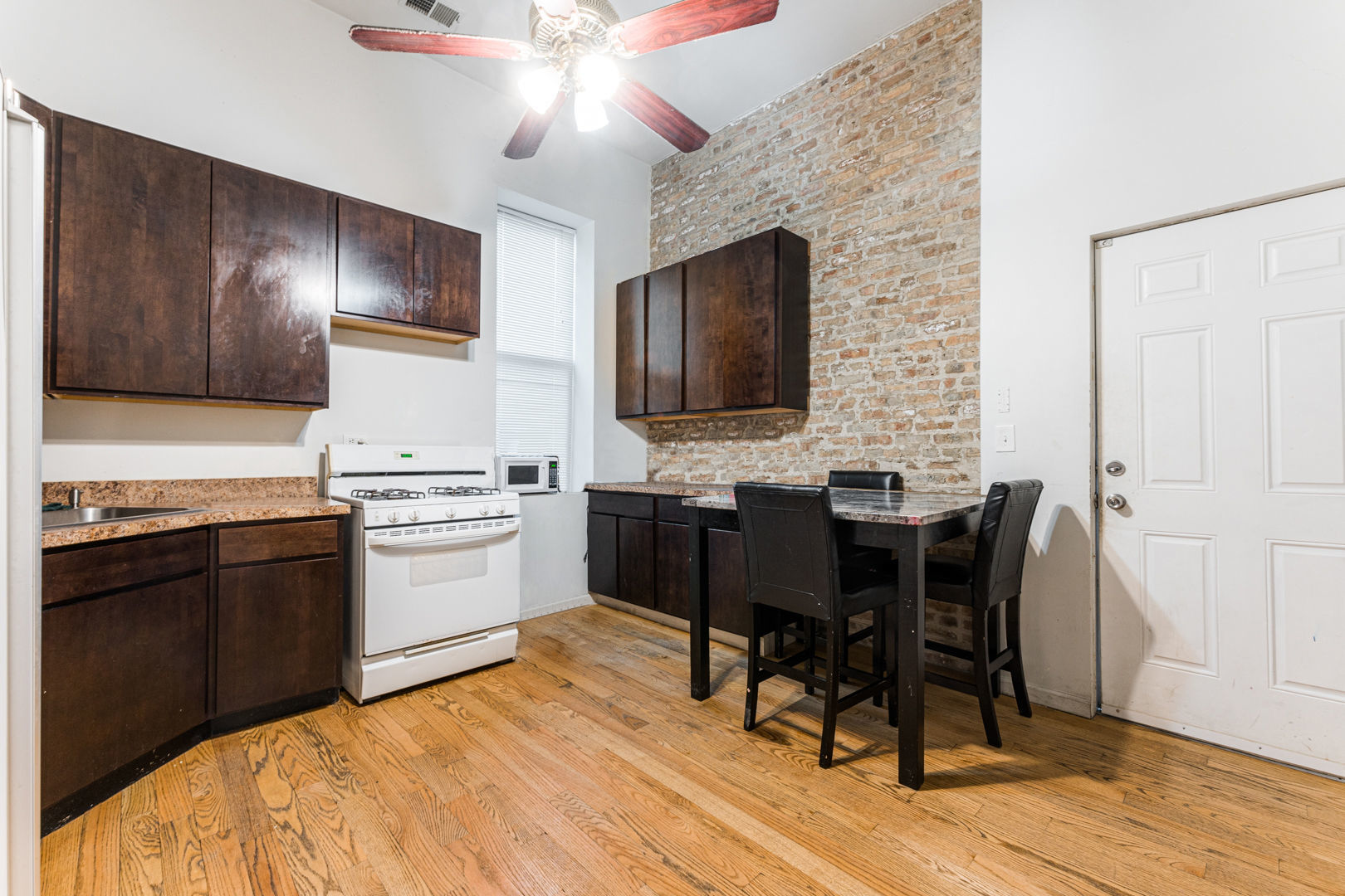 2008 South Pulaski Road Chicago, IL 60623 - Photo 5 of 16 a open kitchen with a dining table and chairs