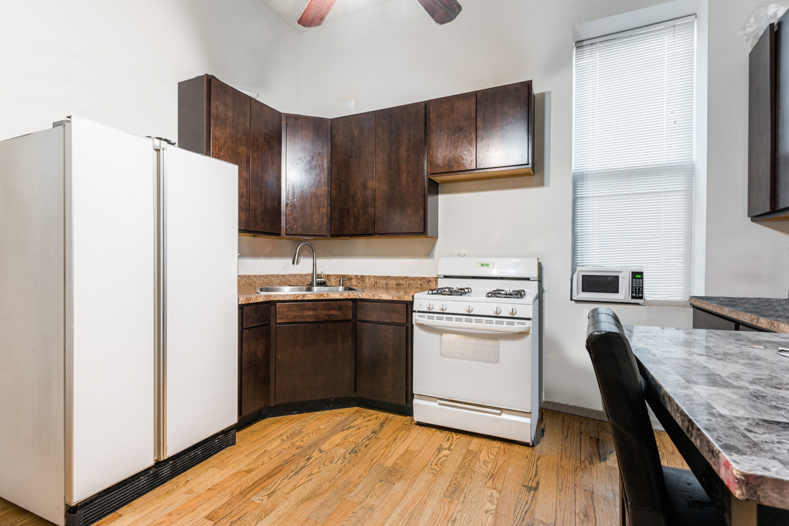 2008 South Pulaski Road Chicago, IL 60623 - Photo 6 of 16 a kitchen with a refrigerator and a stove top oven