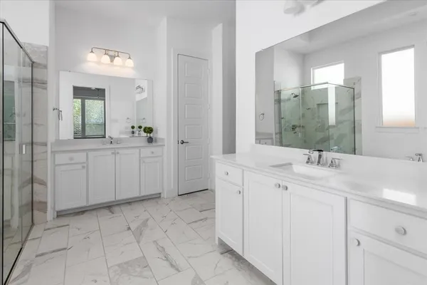a spacious bathroom with a sink and a mirror