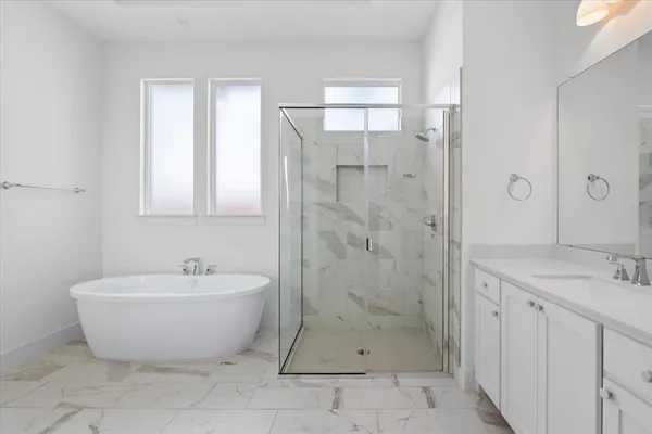 a spacious bathroom with a bathtub and shower