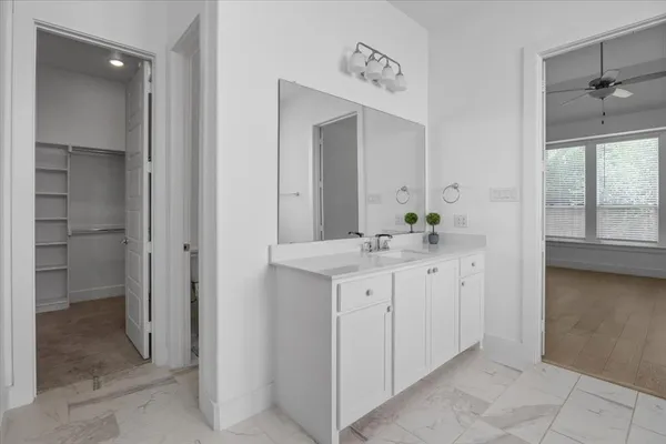 a bathroom with a double vanity sink and a mirror