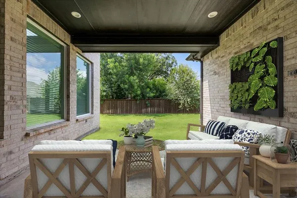 a view of an outdoor dining space with furniture and garden