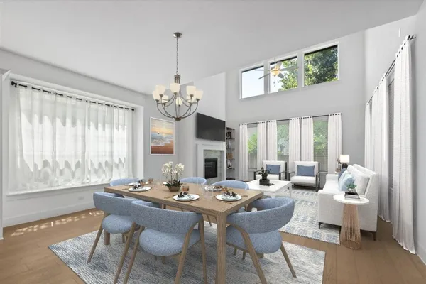 a view of a dining room with furniture a chandelier and wooden floor