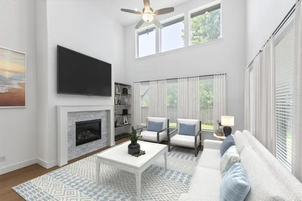 a living room with furniture a fireplace and a flat screen tv