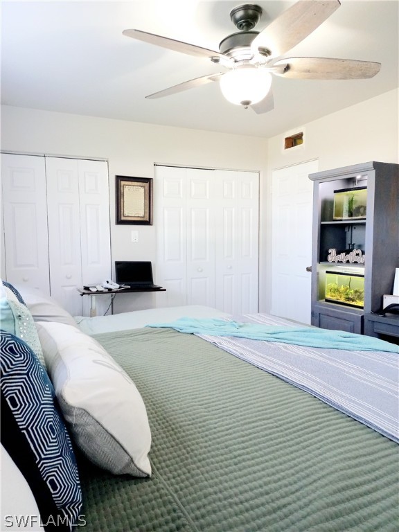 101 Oregon Road North Lehigh Acres, FL 33936 - Photo 26 of 41 a bedroom with a bed and a chandelier
