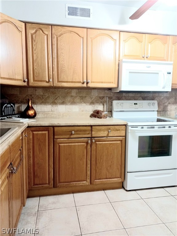 101 Oregon Road North Lehigh Acres, FL 33936 - Photo 33 of 41 a kitchen with stainless steel appliances granite countertop a sink and a stove