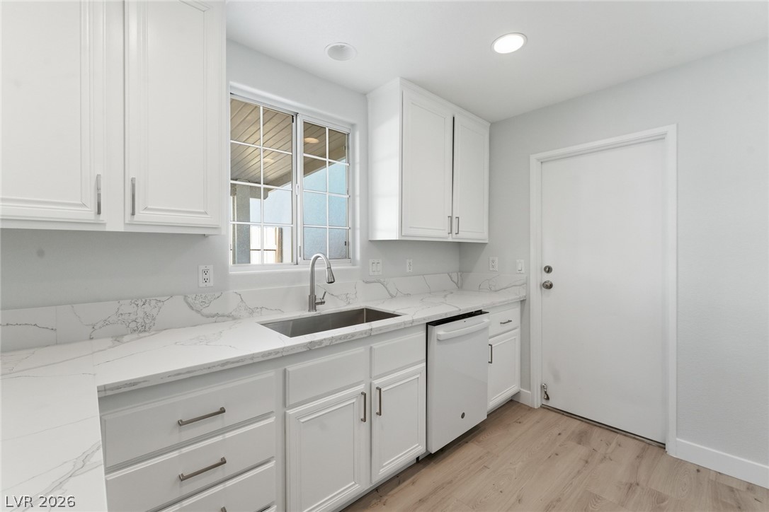 5449 Bugle Way, Unit 104 Las Vegas, NV 89108 - Photo 10 of 33 This bright kitchen features ample cabinetry and a functional layout, perfect for everyday living.