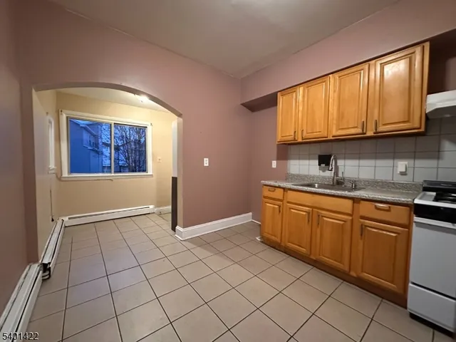 a kitchen with stainless steel appliances granite countertop a refrigerator sink and cabinets