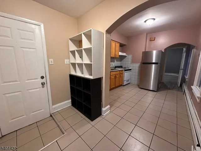 a kitchen with a refrigerator sink and cabinets
