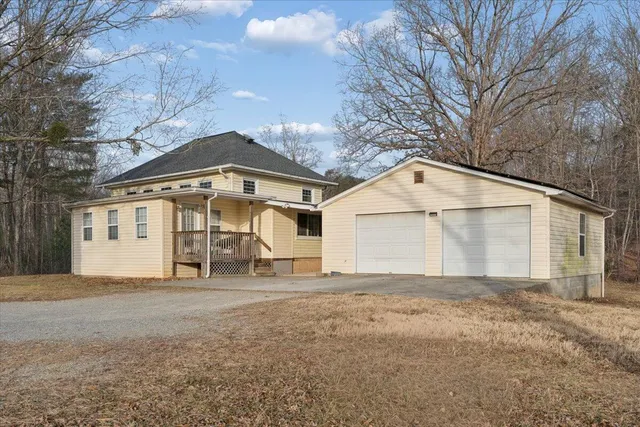 a view of a house with a yard and sitting area