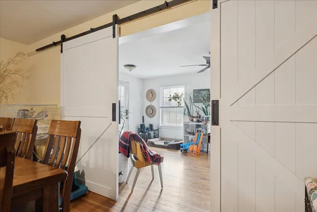 a view of an empty room with wooden floor