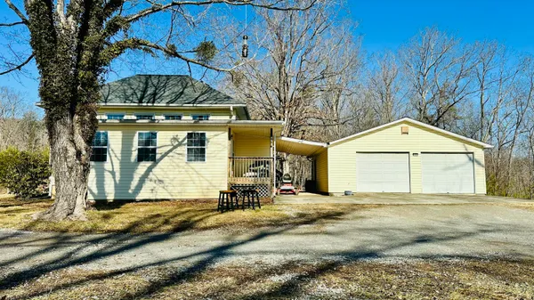 a living room with furniture a chandelier and a window