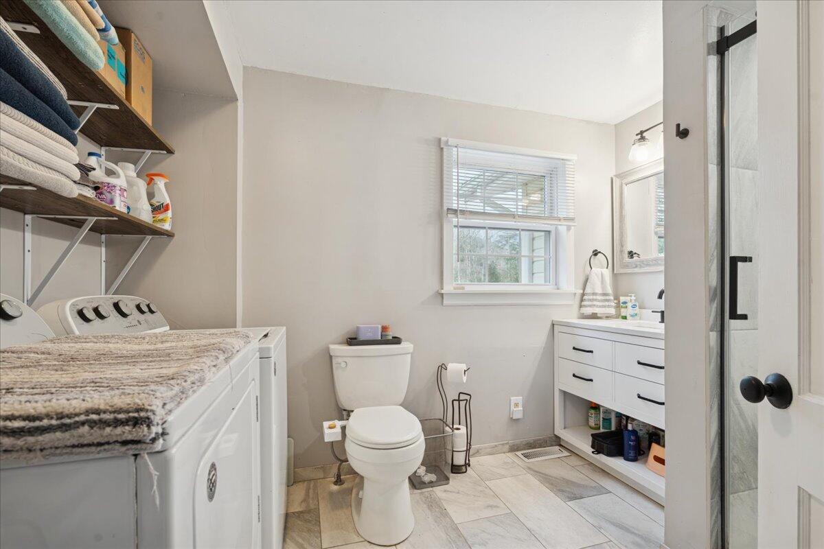 5930 Edwardsville Road Hardy, VA 24101 - Photo 21 of 63 a bathroom with a granite countertop toilet sink and mirror