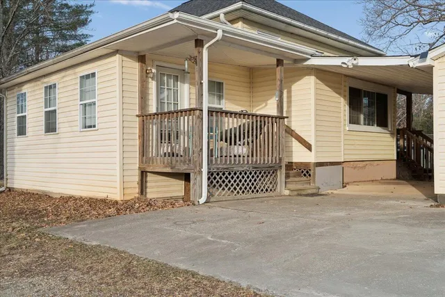 a living room with furniture a chandelier and a window