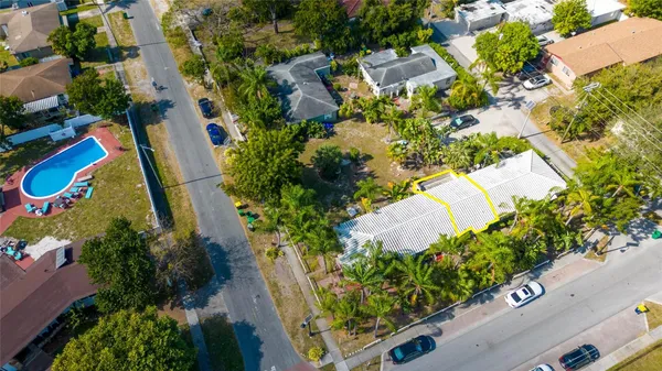 an aerial view of a house with a yard and garden