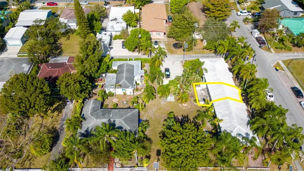 an aerial view of residential house with swimming pool and lawn chairs