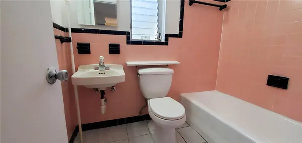 a bathroom with a sink a toilet and mirror
