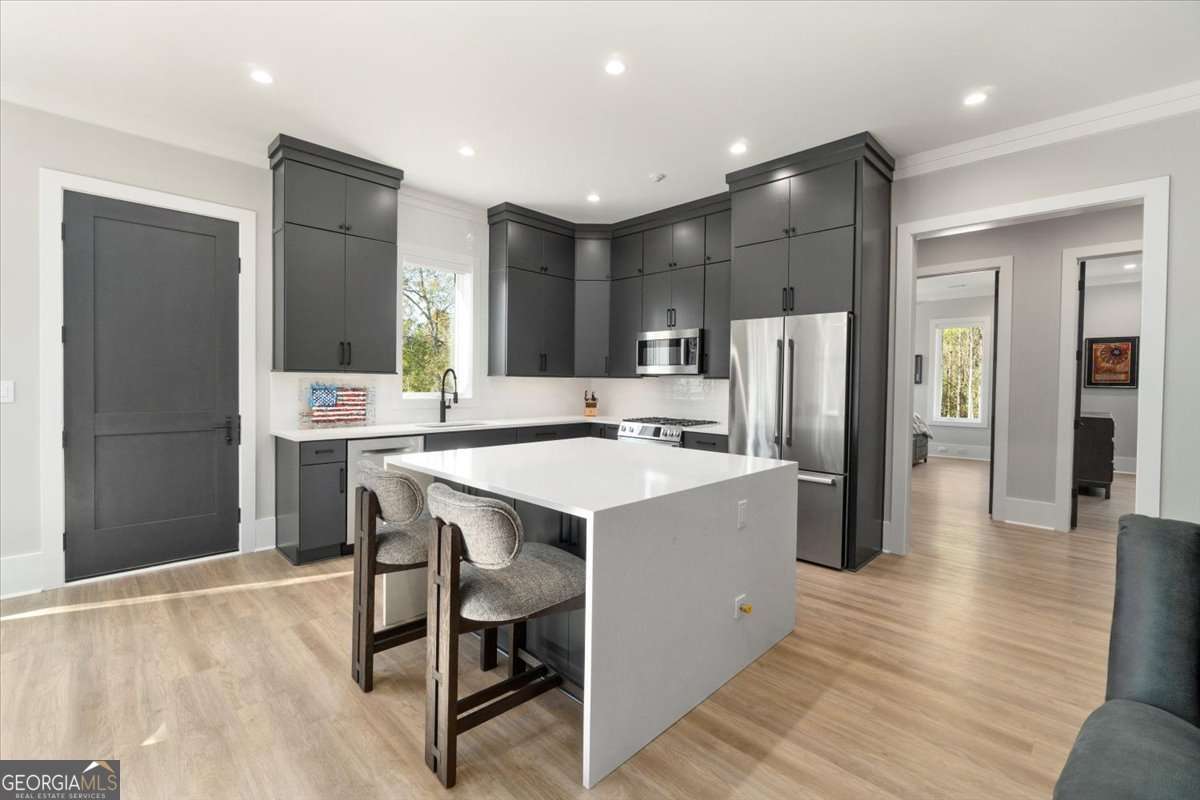 60 Stephens Road Lexington, GA 30648 - Photo 12 of 60 a kitchen with stainless steel appliances a refrigerator a stove a sink dishwasher and a refrigerator with wooden floor