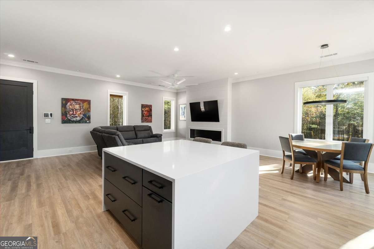 60 Stephens Road Lexington, GA 30648 - Photo 13 of 60 a large living room with stainless steel appliances kitchen island a stove a table and chairs in it