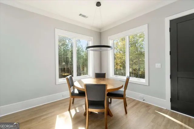a living room with furniture and a view of kitchen