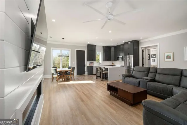 a large kitchen with lots of counter space dining table and stainless steel appliances