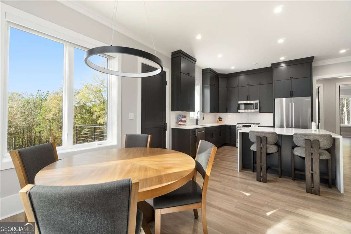 60 Stephens Road Lexington, GA 30648 - Photo 20 of 60 a large kitchen with lots of counter space dining table and stainless steel appliances