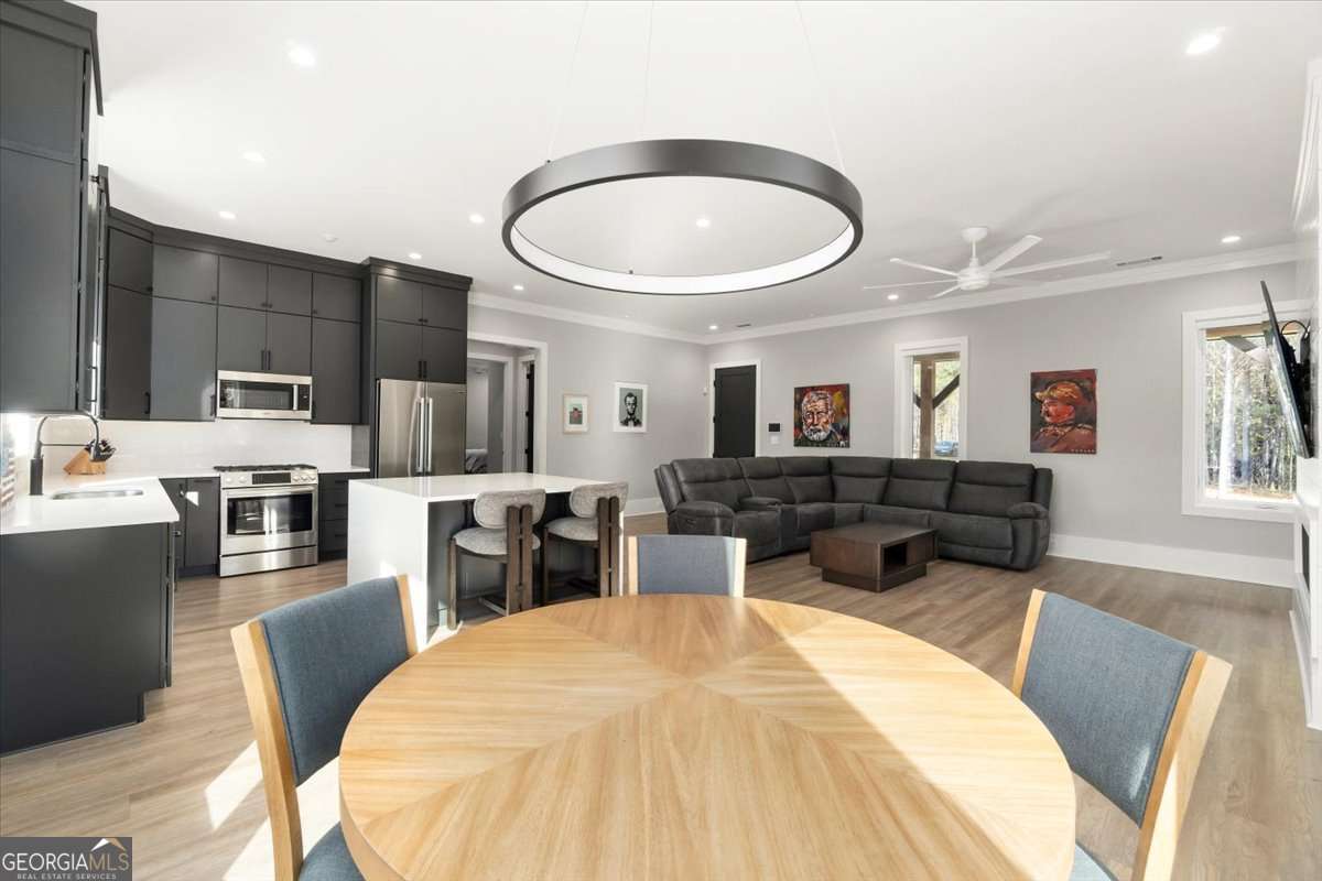 60 Stephens Road Lexington, GA 30648 - Photo 21 of 60 a living room with stainless steel appliances furniture a rug and a kitchen view