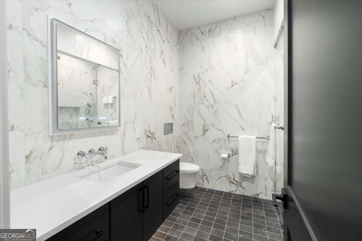 60 Stephens Road Lexington, GA 30648 - Photo 25 of 60 a bathroom with a sink a toilet and a shower