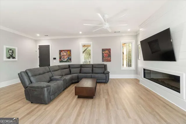 a living room with furniture flat screen tv and a fireplace