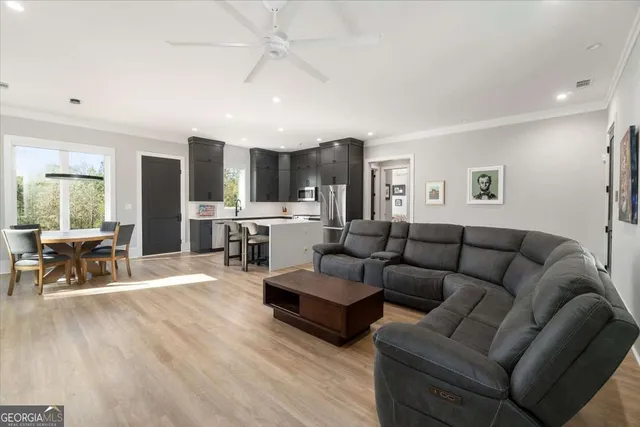 a living room with fireplace furniture and a wooden floor