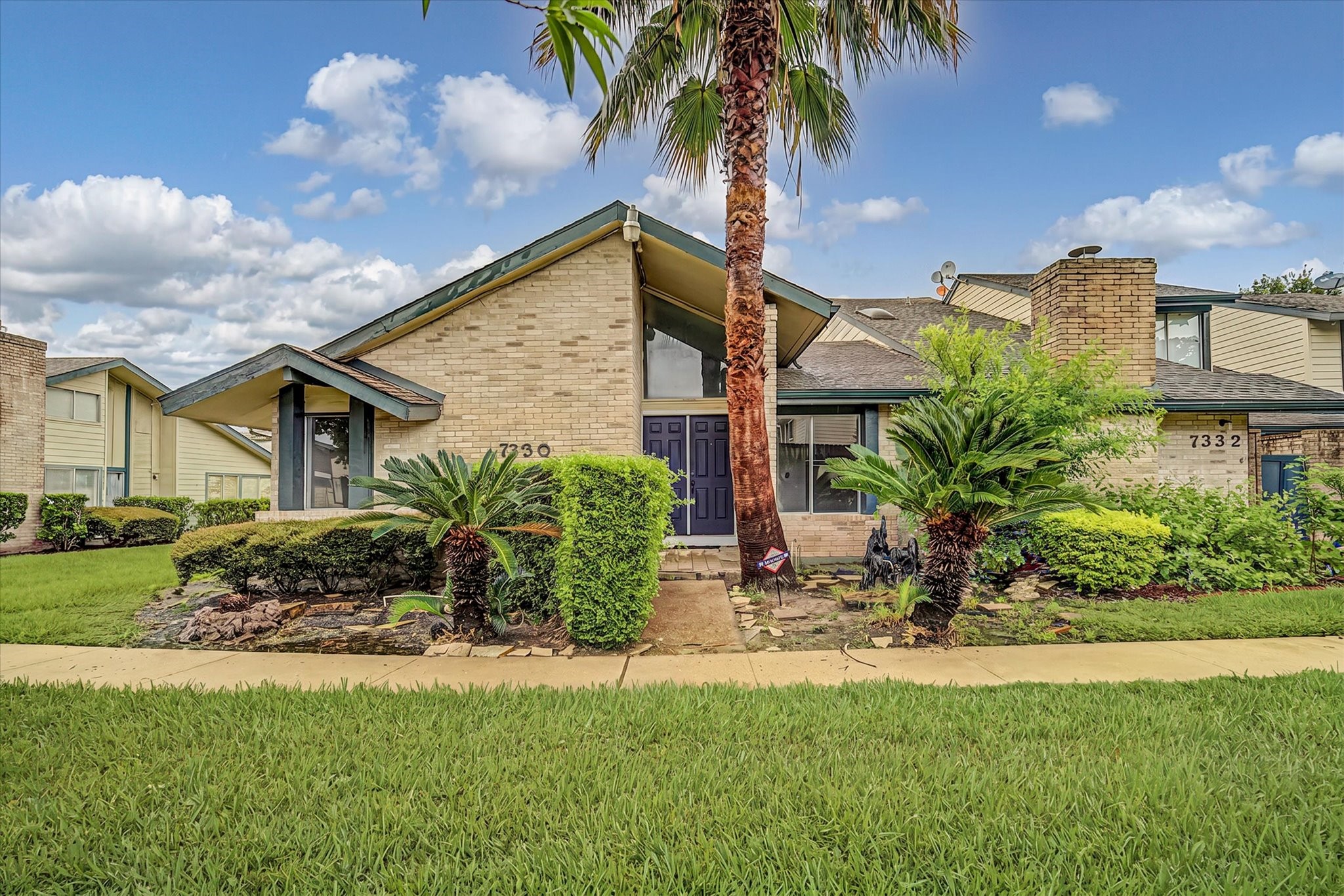 7330 South Dairy Ashford Road Houston, TX 77072 - Photo 1 of 33 a front view of a house with a garden and patio