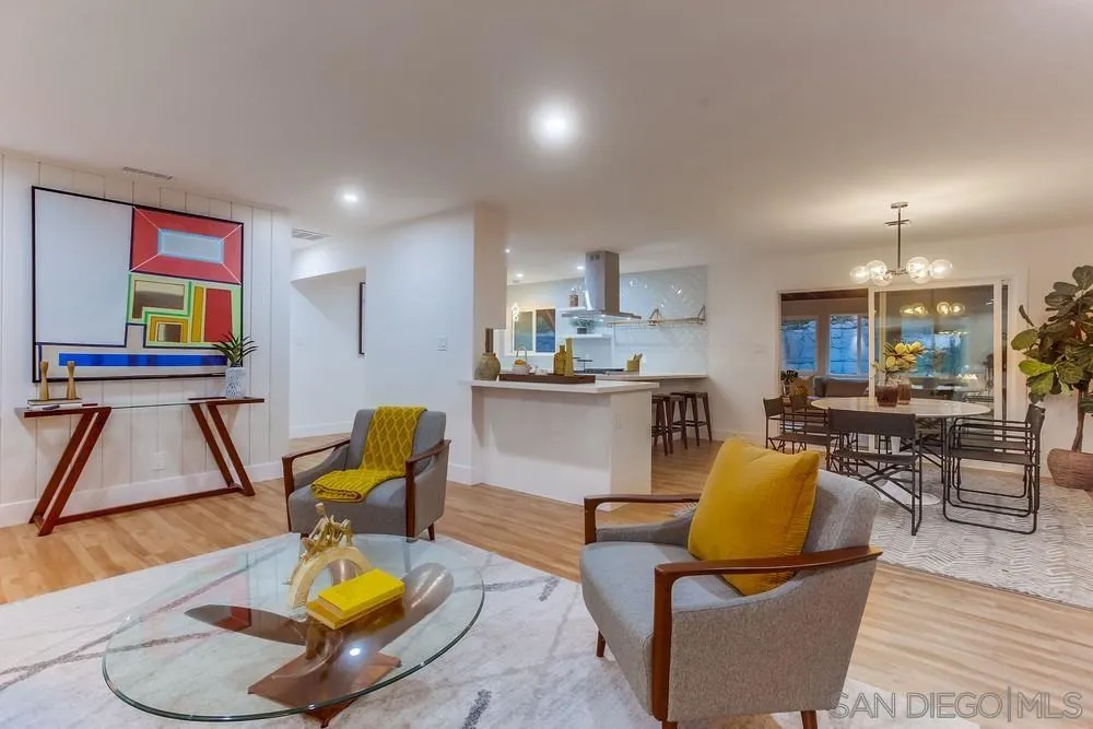a living room with furniture and kitchen view
