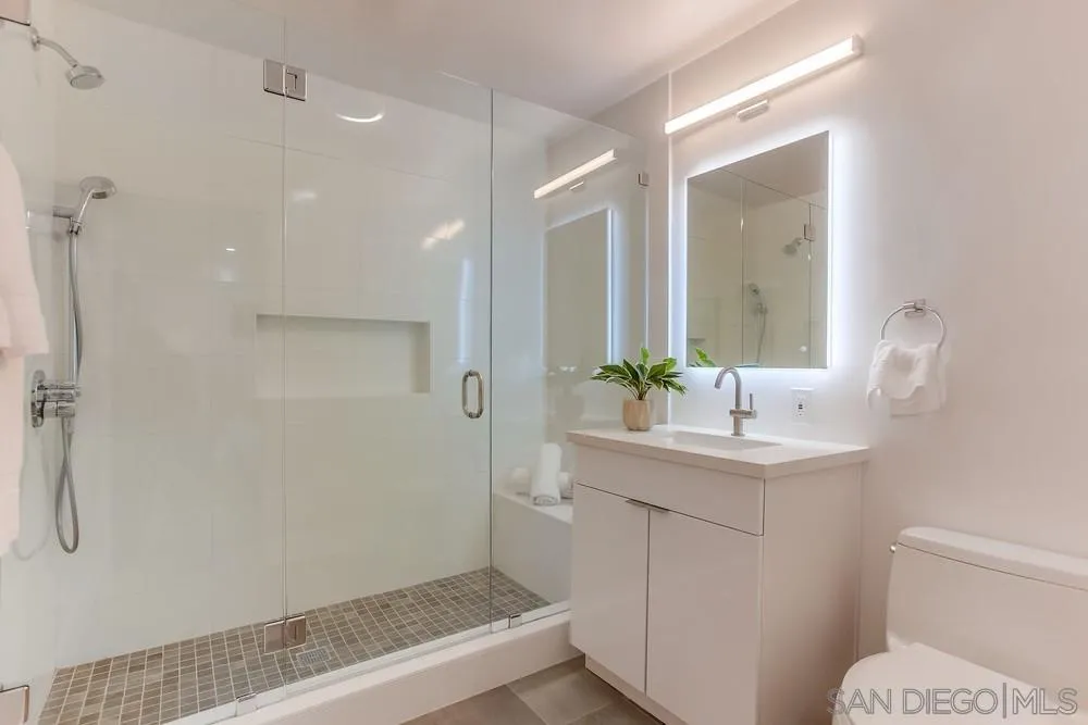 1822 Ivy Road Oceanside, CA 92054 - Photo 21 of 30 a bathroom with a sink a toilet a shower and a mirror