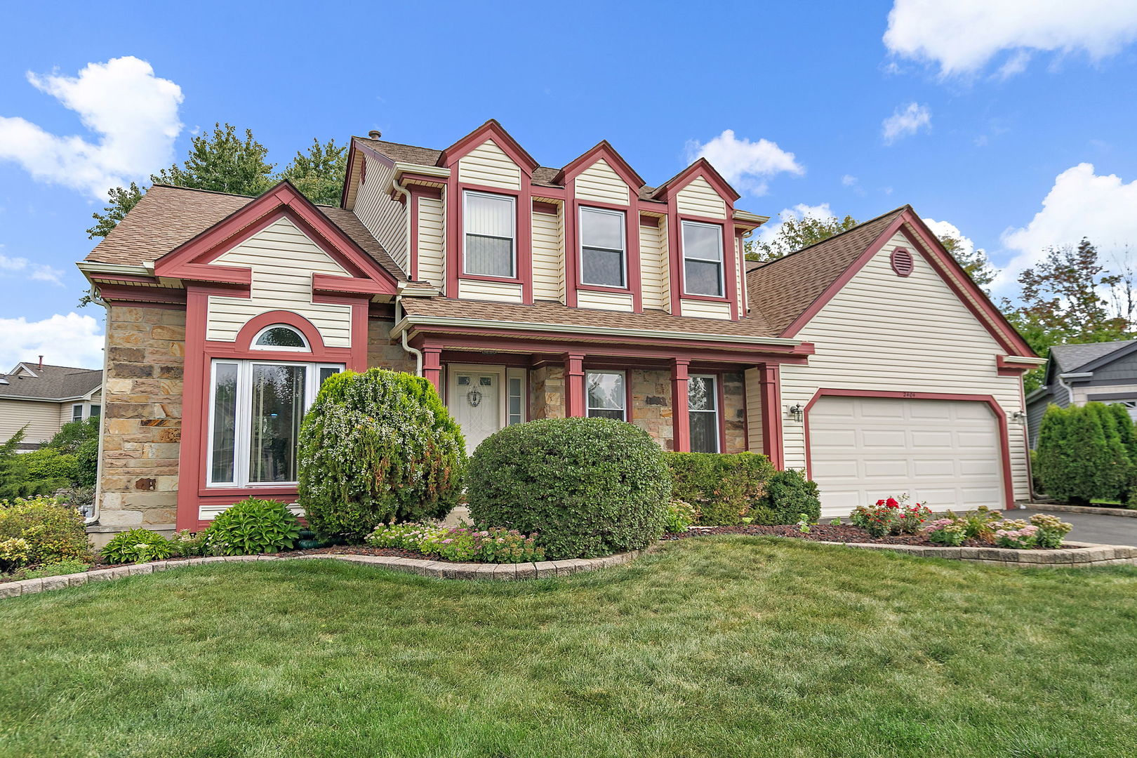 a front view of a house with a yard and garage