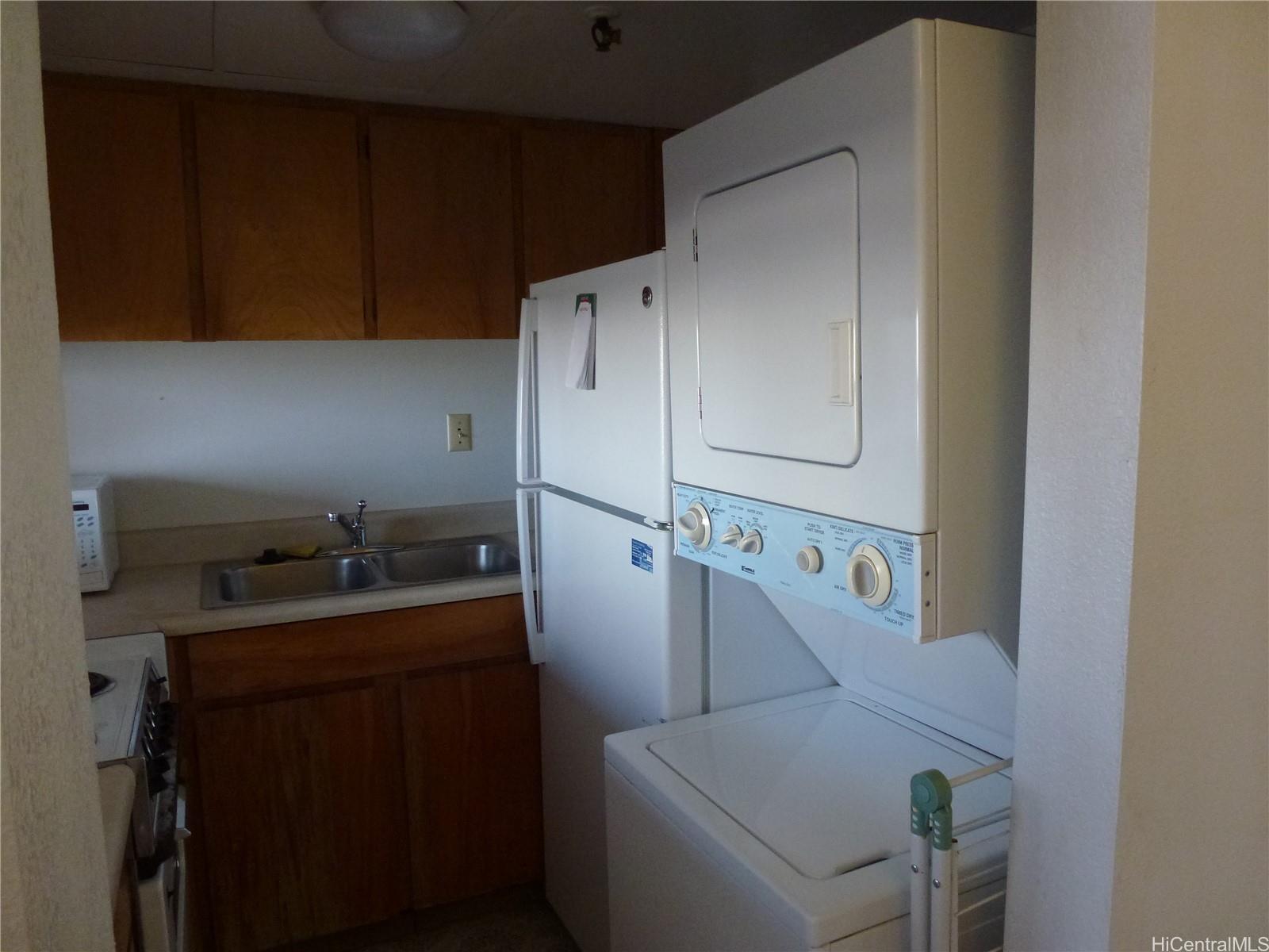2499 Kapiolani Boulevard, Unit 1102 Honolulu, HI 96826 - Photo 2 of 4 a room with a refrigerator and a sink