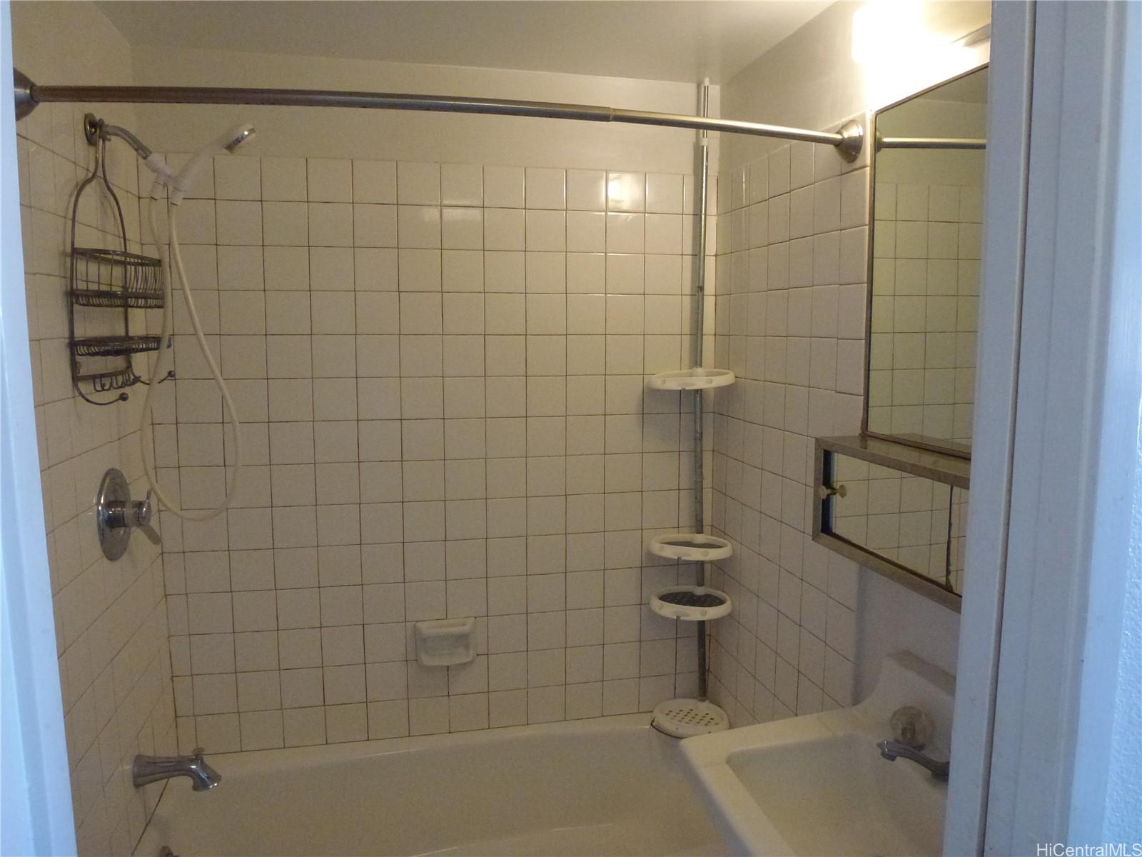2499 Kapiolani Boulevard, Unit 1102 Honolulu, HI 96826 - Photo 3 of 4 a bathroom with a shower and a bath tub