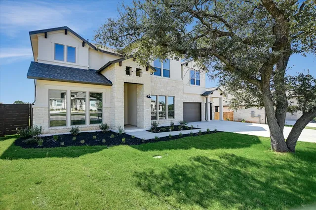 a front view of a house with a yard and garage